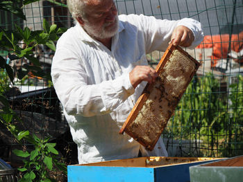 Midsection of man working at farm