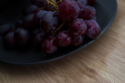 High angle view of grapes in bowl on table