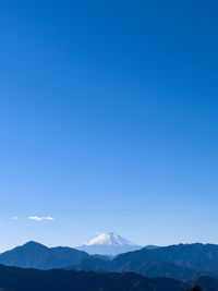 Scenic view of mountains against clear blue sky