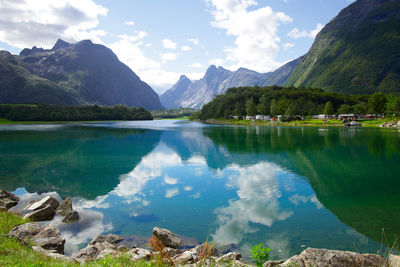 Scenic view of lake and mountains against sky