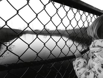 Close-up of chainlink fence against sky