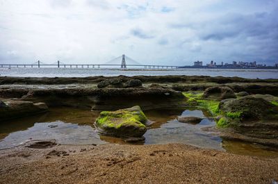 Bridge over sea against sky