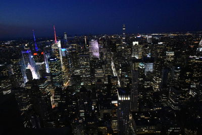 Aerial view of illuminated buildings in city at night