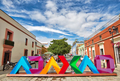 Multi colored houses in playground against sky