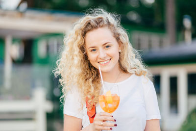 Portrait of smiling woman holding ice cream