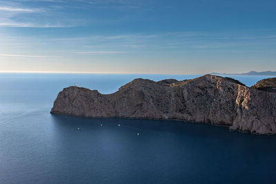 Mountains with the sea against the sky 
illuminated by the morning sun