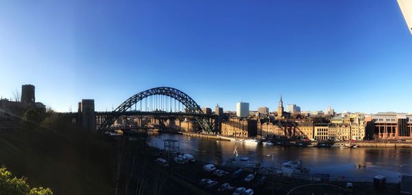 View of bridge over river against blue sky