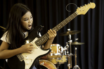 Young woman playing guitar