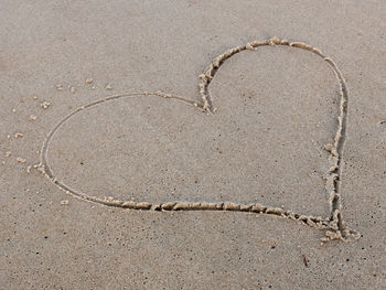 Directly above shot of heart shape on sand