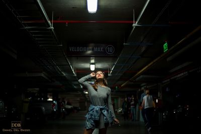 Full length portrait of young woman standing in bus