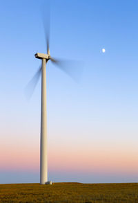 Colorado wind farm located on wheat field at sunset