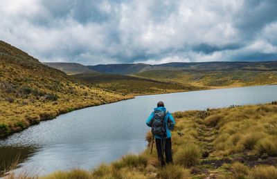 Rear view of a backpacker at lake ellis in chogoria route, mount kenya national park, kenya