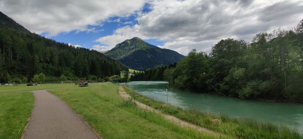 Scenic view of river by mountains against sky and lake