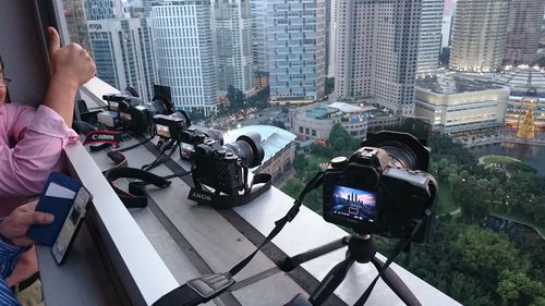 Cameras on tripods at window sill