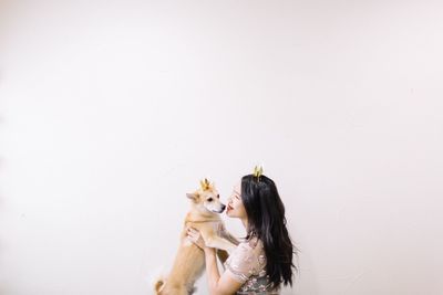 Woman with dog against white background