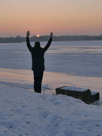 Full length of man standing on beach during sunset