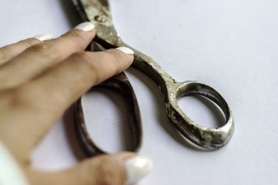 Close-up of hand holding metal