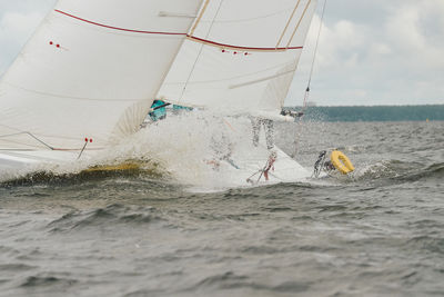 Boat sailing on sea against sky