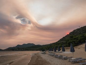 Panoramic view of beach against sky during sunset