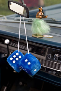 Close-up of blue toy hanging in car