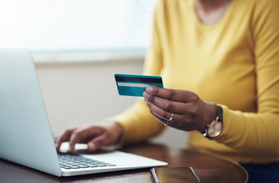 Midsection of woman with credit card