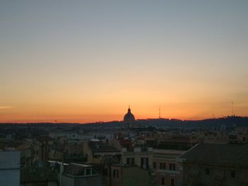 High angle shot of townscape against clear sky at sunset