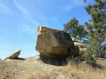 Low angle view of rocks against blue sky