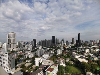 Aerial view of buildings in city against sky