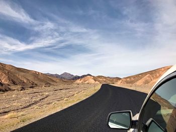 Panoramic view of road amidst mountains against sky