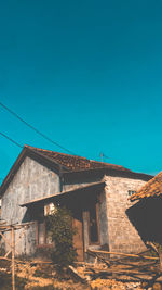 Low angle view of old building against clear blue sky