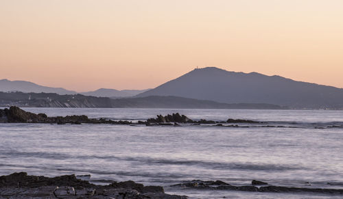 Scenic view of sea against clear sky during sunset