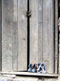 High angle view of shoes on closed door