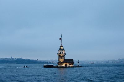 Scenic view of sea by building against sky