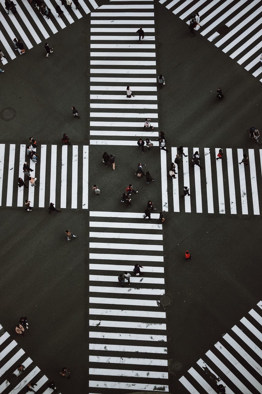 HIGH ANGLE VIEW OF PEOPLE CROSSING ROAD IN CITY