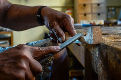 Violin maker luthier hand working a new violin scroll in cremona italy