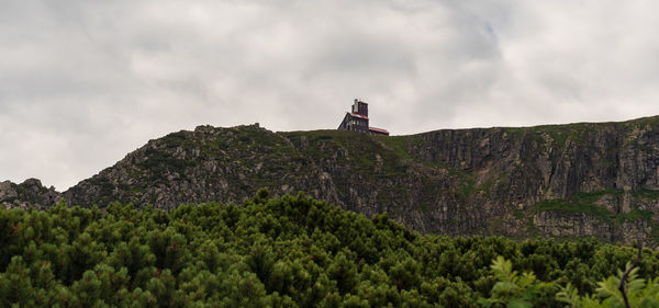 Low angle view of flag on mountain against sky