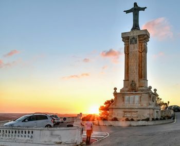 Traditional building against sky during sunset