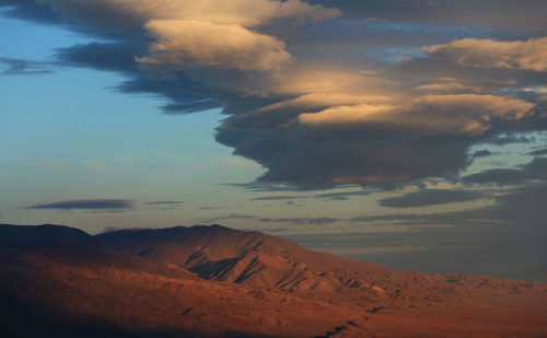 Scenic view of desert against sky during sunset