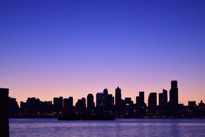 Scenic view of silhouette buildings against sky during sunset