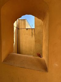 Rear view of woman standing in tunnel
