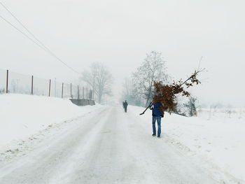 People walking on snow covered road