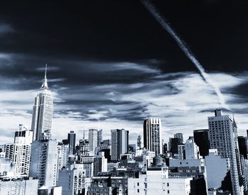 Skyscrapers against cloudy sky