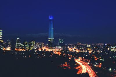 Illuminated cityscape against sky at night