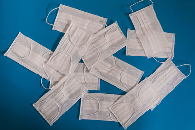 High angle view of paper flag on table against blue background