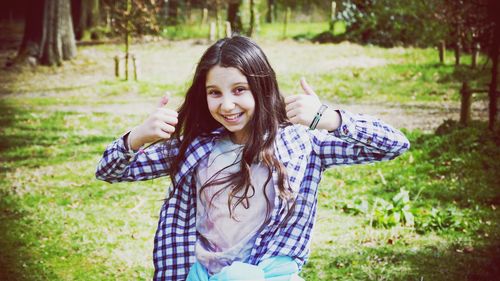 Portrait of smiling girl standing outdoors