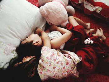 High angle view of cute girl sleeping on bed