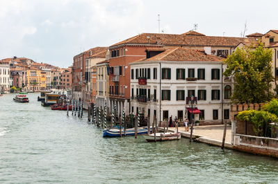 Boats in canal against buildings in city