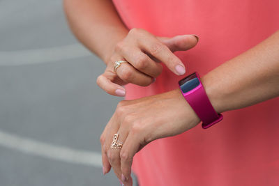Midsection of woman using smart watch