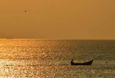 Scenic view of sea against clear sky during sunset