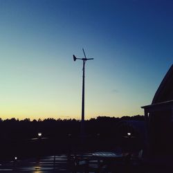 Silhouette of windmill against clear sky at sunset